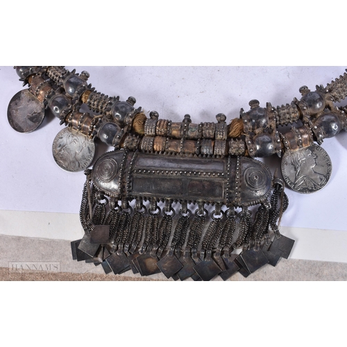 1948 - A FINE OMANI SILVER AND YELLOW METAL TRIBAL NECKLACE inset with multiple coins. 1170 grams overall. ... 