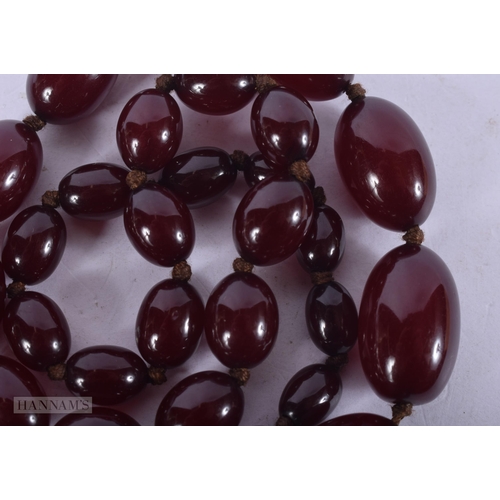 2652 - A CHERRY AMBER TYPE NECKLACE. 71 grams. 108 cm long.