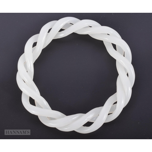 2655 - A CHINESE WHITE JADE TWIST BANGLE. 39.7 grams. 6.5 cm internal diameter.