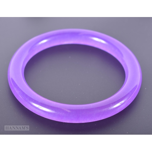 2657 - A CHINESE LAVENDER JADEITE BANGLE. 32.6 grams. 5.5 cm internal diameter.