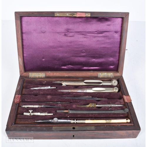 3010 - A boxed case of drawing instruments together with a brass sewing Etui, set of scales and an onyx pen... 