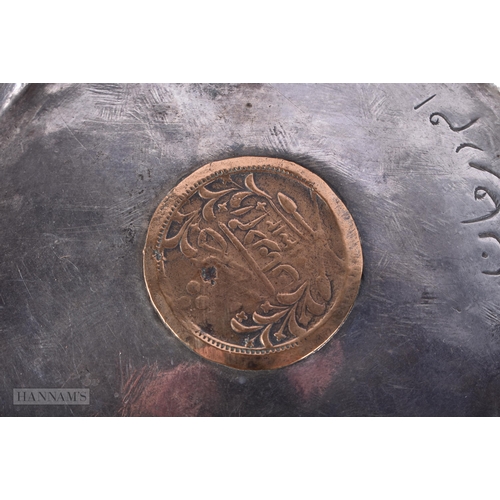 4097 - AN ISLAMIC WHITE METAL COIN INSET DISH together with six other dishes inset with Thai coins. 256 gra... 