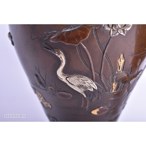 10 - A PAIR OF 19TH CENTURY JAPANESE MEIJI PERIOD GOLD AND SILVER ONLAID VASES decorated with birds perch... 