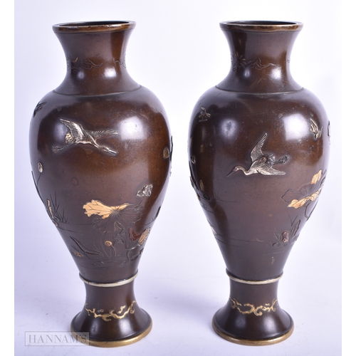 10 - A PAIR OF 19TH CENTURY JAPANESE MEIJI PERIOD GOLD AND SILVER ONLAID VASES decorated with birds perch... 