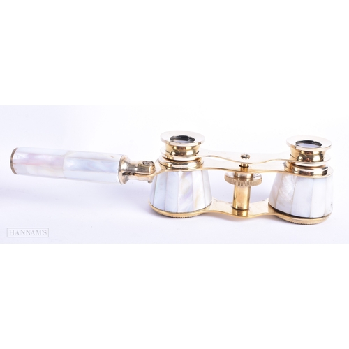 114 - A GROUP OF FOUR MOTHER OF PEARL OPERA GLASSES. Largest 18 cm wide extended. (4)