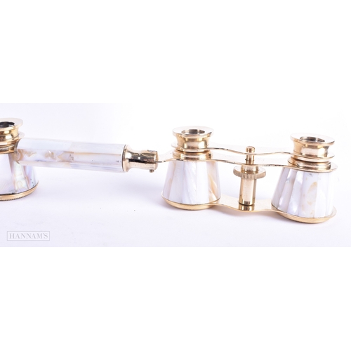 115 - A GROUP OF FOUR MOTHER OF PEARL OPERA GLASSES. Largest 18 cm wide extended. (4)