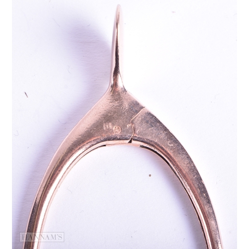 123 - A PAIR OF 9CT GOLD WISHBONE TONGS. 18.3 grams. 8.5 cm x 3.5 cm.