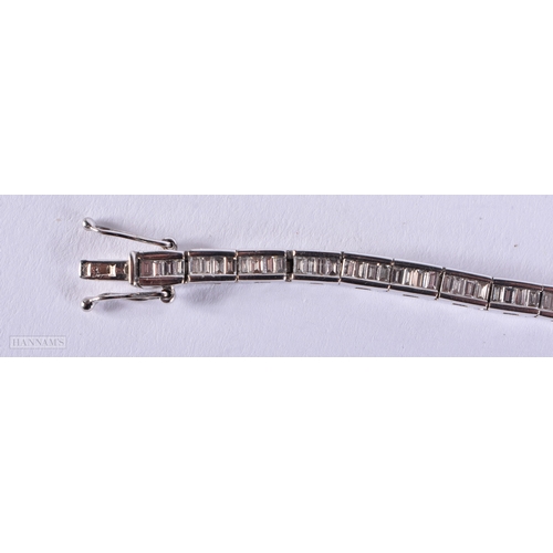 171 - AN 18CT WHITE GOLD AND BAGUETTE CUT DIAMOND TENNIS BRACELET. 15.4 grams. 19.5 cm long.