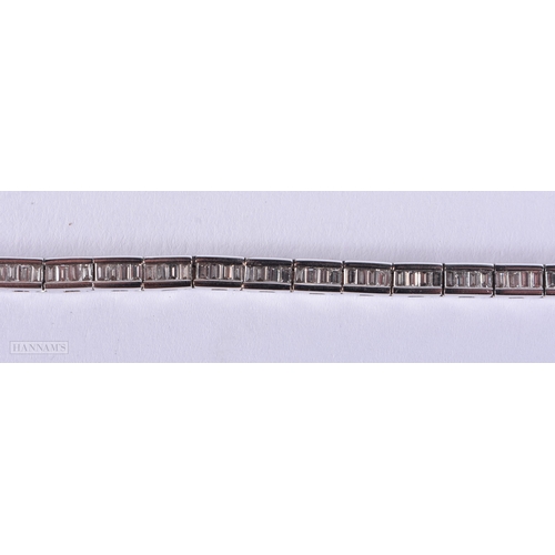 171 - AN 18CT WHITE GOLD AND BAGUETTE CUT DIAMOND TENNIS BRACELET. 15.4 grams. 19.5 cm long.