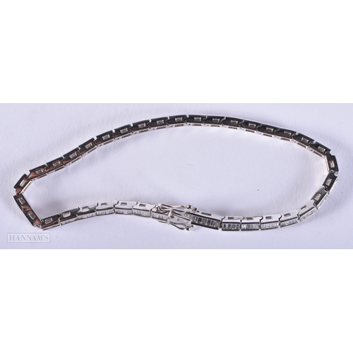 171 - AN 18CT WHITE GOLD AND BAGUETTE CUT DIAMOND TENNIS BRACELET. 15.4 grams. 19.5 cm long.