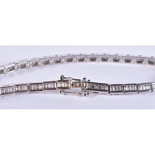 171 - AN 18CT WHITE GOLD AND BAGUETTE CUT DIAMOND TENNIS BRACELET. 15.4 grams. 19.5 cm long.