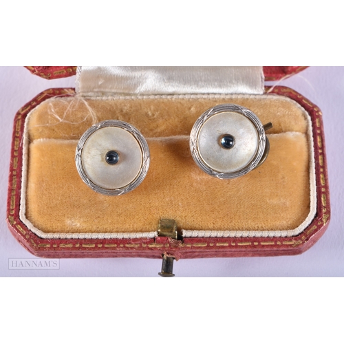 184 - A CASED SET OF EDWARDIAN YELLOW AND WHITE METAL DRESS STUDS. 4.5 grams. 1.5 cm diameter.