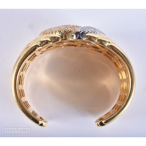 185 - A FINE 18CT GOLD AND DIAMOND CUFF BANGLE. 109.7 grams. 7.5 cm wide.