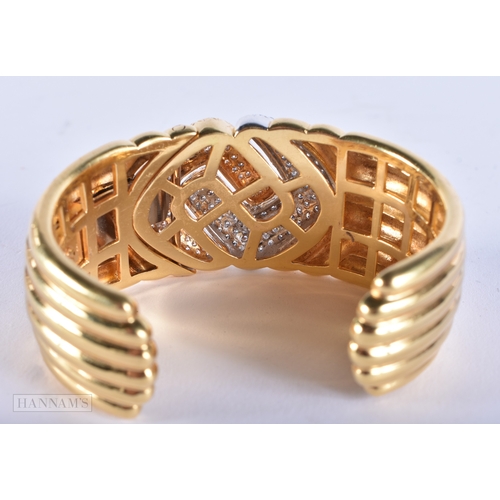 185 - A FINE 18CT GOLD AND DIAMOND CUFF BANGLE. 109.7 grams. 7.5 cm wide.