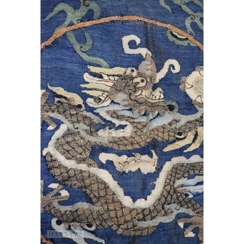 201 - A CHINESE QING DYNASTY SILK DRAGON EMBROIDERY. 93 cm diameter.