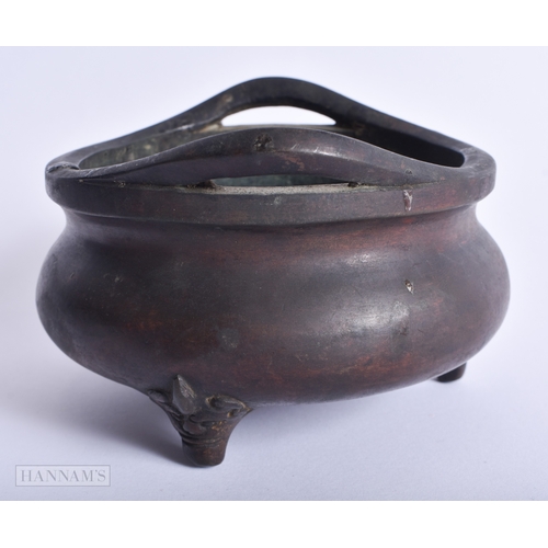 202 - A CHINESE QING DYNASTY TWIN HANDLED BRONZE CENSER bearing Ming inscription to inner body. 759 grams.... 