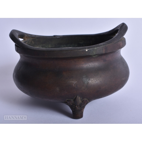 202 - A CHINESE QING DYNASTY TWIN HANDLED BRONZE CENSER bearing Ming inscription to inner body. 759 grams.... 