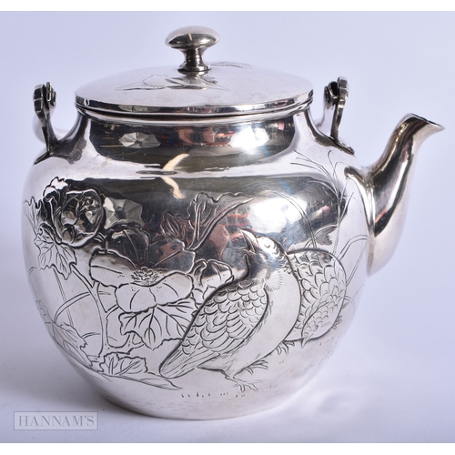 203 - A FINE 19TH CENTURY JAPANESE MEIJI PERIOD SILVER TEAPOT decorated with game birds and foliage. 231 g... 