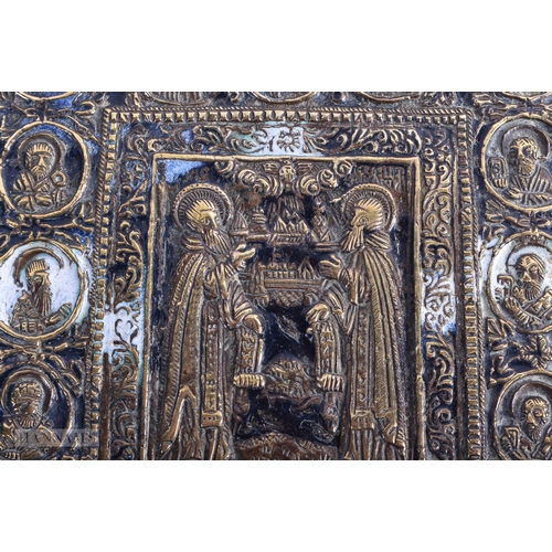 21 - AN 18TH CENTURY RUSSIAN ENAMELLED BRONZE ICON decorated with extensive saints and Cyrillic scripture... 