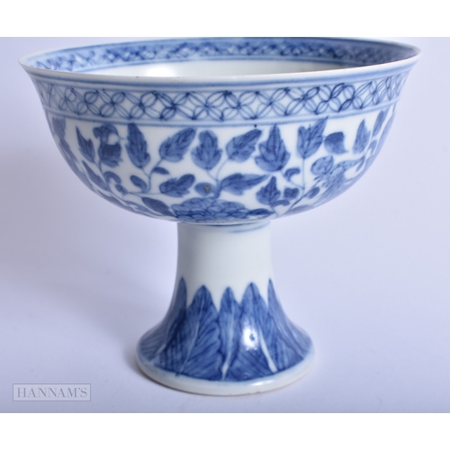 214 - A CHINESE QING DYNASTY BLUE AND WHITE PORCELAIN STEM CUP painted with phoenix birds. 13.75 cm wide.