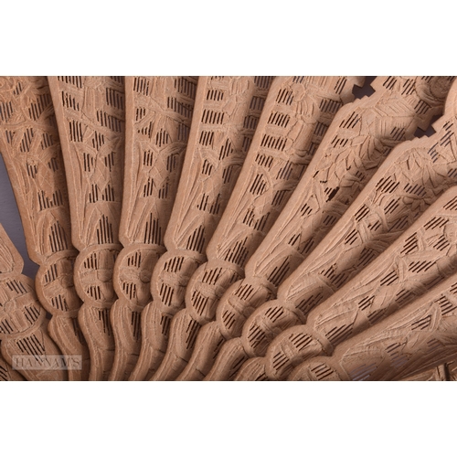 215 - A 19TH CENTURY CHINESE CARVED SANDALWOOD FAN Qing. 50 cm wide extended.