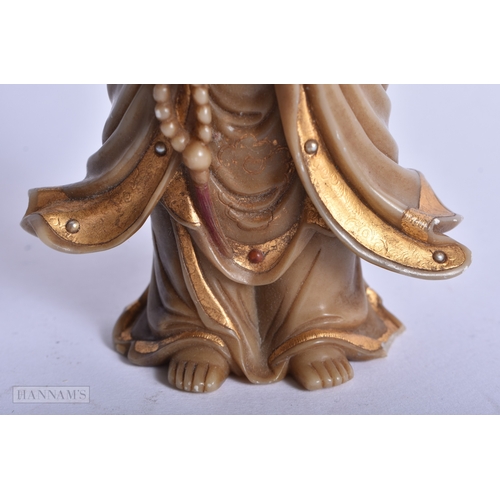 220 - A CHINESE QING DYNASTY GILDED SOAPSTONE FIGURE OF GUANYIN. 16 cm high.