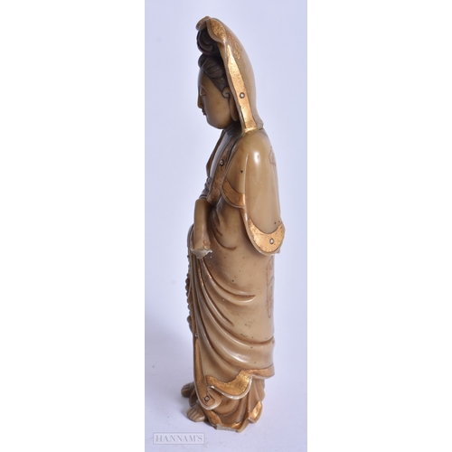 220 - A CHINESE QING DYNASTY GILDED SOAPSTONE FIGURE OF GUANYIN. 16 cm high.