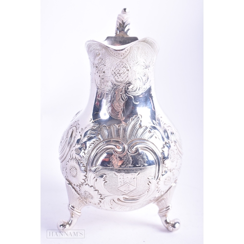 30 - A GEORGE III SILVER REPOUSSE JUG C1770. 157.2 grams. 13 cm x 9.5 cm.