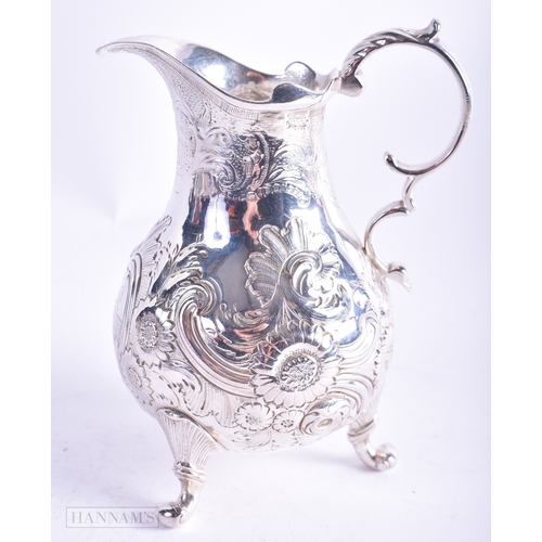 30 - A GEORGE III SILVER REPOUSSE JUG C1770. 157.2 grams. 13 cm x 9.5 cm.