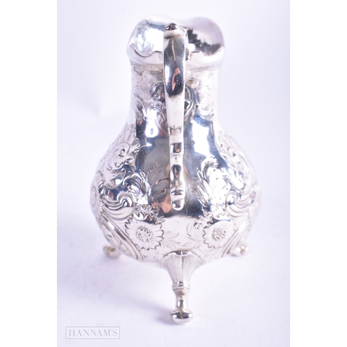 30 - A GEORGE III SILVER REPOUSSE JUG C1770. 157.2 grams. 13 cm x 9.5 cm.