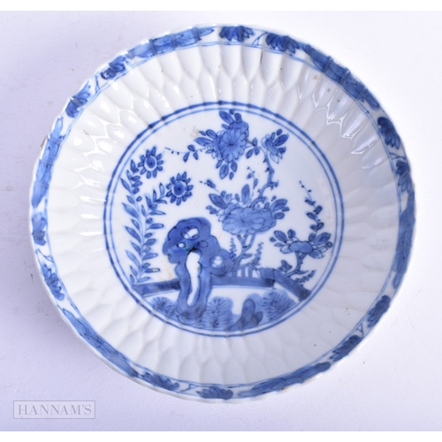 5 - A PAIR OF 17TH CENTURY CHINESE BLUE AND WHITE BARBED SAUCERS Kangxi, painted with a fenced garden. 1... 