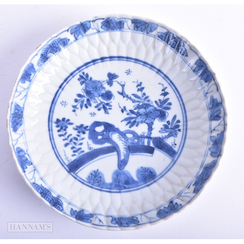 5 - A PAIR OF 17TH CENTURY CHINESE BLUE AND WHITE BARBED SAUCERS Kangxi, painted with a fenced garden. 1... 