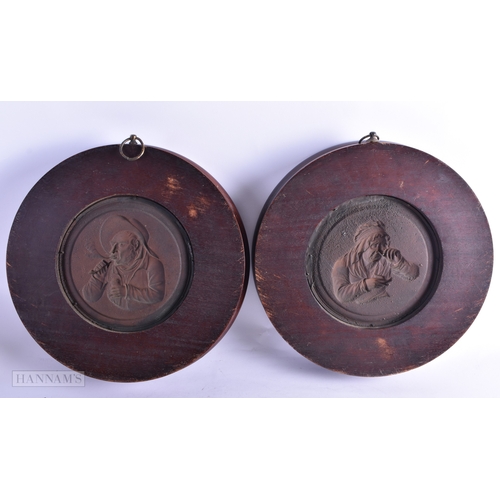 54 - A LARGE PAIR OF 19TH CENTURY PATINATED COPPER REPOUSSE PANELS contained within oak frames. 29 cm dia... 