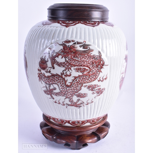 64 - A CHINESE QING DYNASTY IRON RED PAINTED GINGER JAR AND COVER painted with phoenix birds and dragons.... 