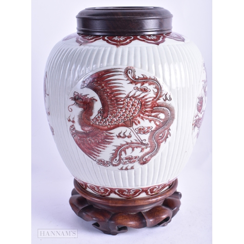 64 - A CHINESE QING DYNASTY IRON RED PAINTED GINGER JAR AND COVER painted with phoenix birds and dragons.... 