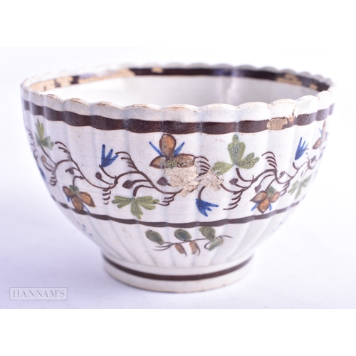 75 - AN 18TH CENTURY ENGLISH CREAMWARE TEABOWL AND SAUCER together with two Delft plates. Largest 21 cm d... 