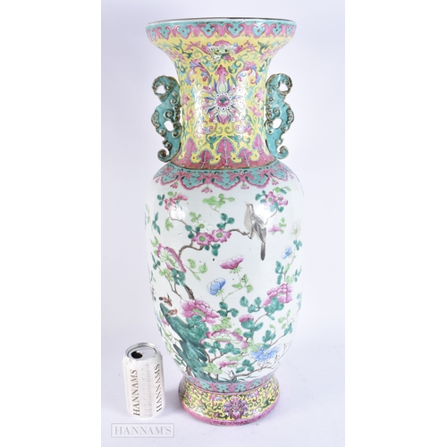 609 - A VERY LARGE 19TH CENTURY CHINESE TWIN HANDLED PORCELAIN VASE Qing, painted with bold enamelled flow... 