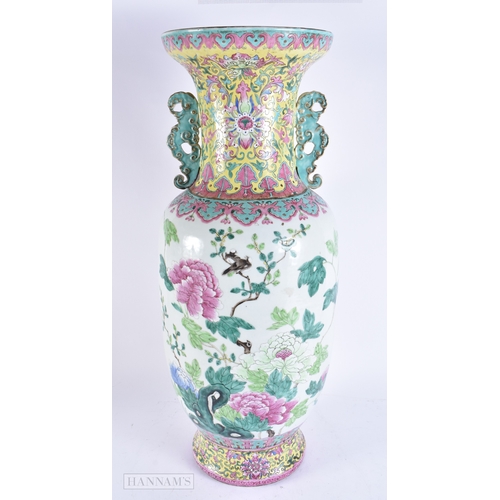 609 - A VERY LARGE 19TH CENTURY CHINESE TWIN HANDLED PORCELAIN VASE Qing, painted with bold enamelled flow... 