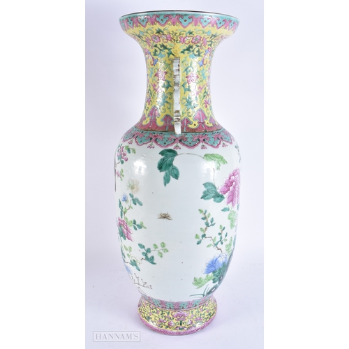 609 - A VERY LARGE 19TH CENTURY CHINESE TWIN HANDLED PORCELAIN VASE Qing, painted with bold enamelled flow... 