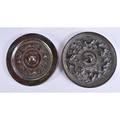 610 - TWO EARLY CHINESE SILVERED BRONZE HAND MIRRORS one decorated with animals, the other with motifs. La... 