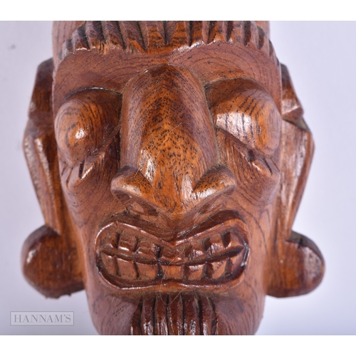 101 - AN EASTER ISLANDS CARVED WOOD FIGURE OF A MALE. 38 cm high.