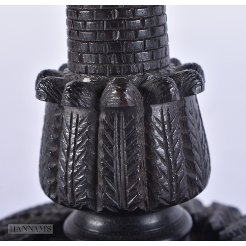 104 - A 19TH CENTURY IRISH CARVED BOG OAK CANDLESTICK. 15 cm high.