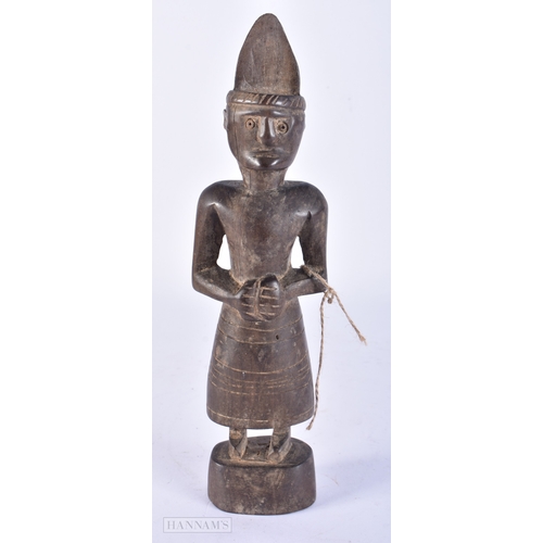 106 - AN UNUSUAL TRIBAL CARVED WOOD FIGURE. 25cm high.