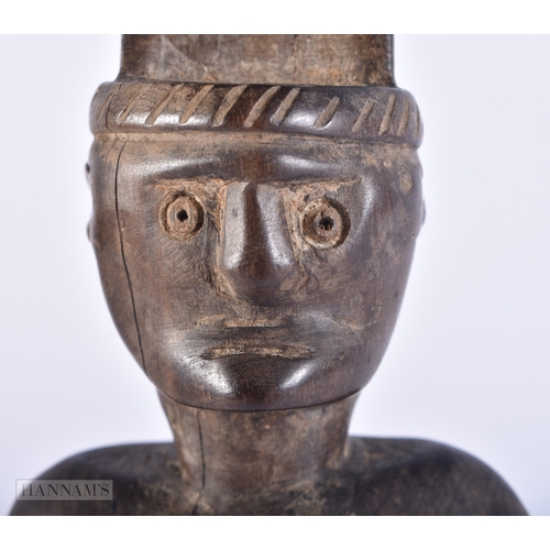 106 - AN UNUSUAL TRIBAL CARVED WOOD FIGURE. 25cm high.