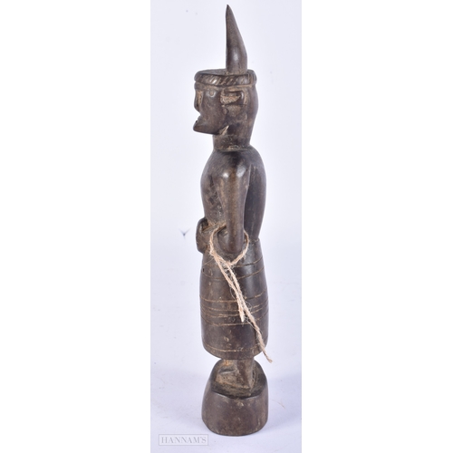 106 - AN UNUSUAL TRIBAL CARVED WOOD FIGURE. 25cm high.