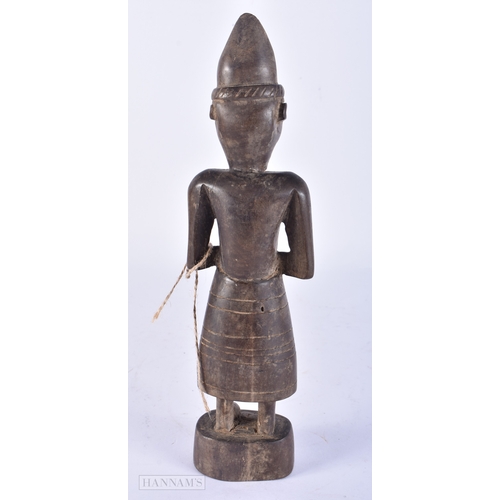 106 - AN UNUSUAL TRIBAL CARVED WOOD FIGURE. 25cm high.