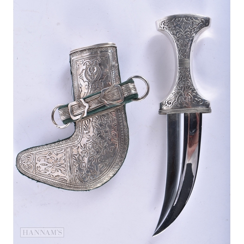 111 - A LARGE MIDDLE EASTERN SILVER OVERLAID JAMBIYA DAGGER. 28cm x 14 cm.