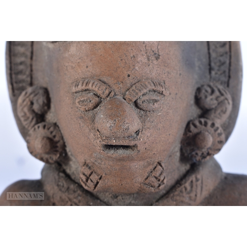 113 - A SOUTH AMERICAN POTTERY FIGURE OF A TRIBAL MALE. 24 cm high.