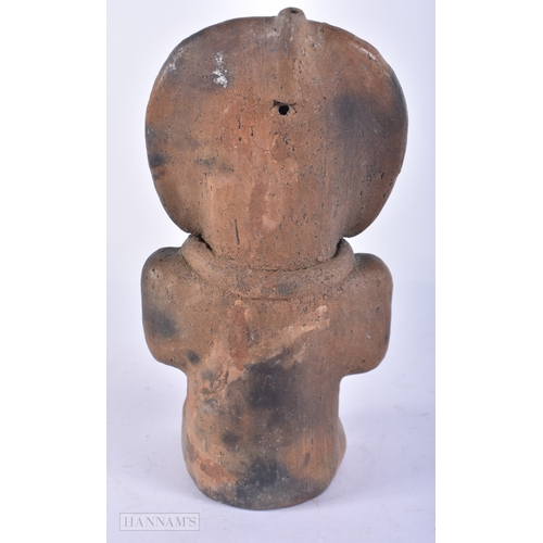 113 - A SOUTH AMERICAN POTTERY FIGURE OF A TRIBAL MALE. 24 cm high.