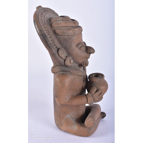 113 - A SOUTH AMERICAN POTTERY FIGURE OF A TRIBAL MALE. 24 cm high.